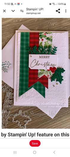 a christmas card with holly and mist on it, sitting next to two envelopes