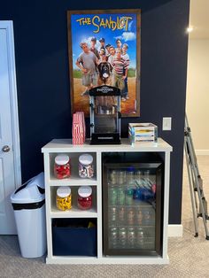 a small bar with drinks and snacks on it in front of a poster that reads the sandlot