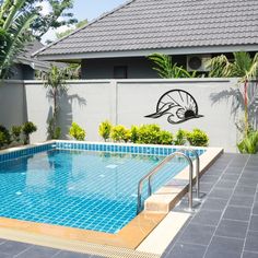 an empty swimming pool in front of a house