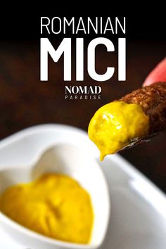 a close up of a spoon with some food in it and the words roman mici nomad paradise