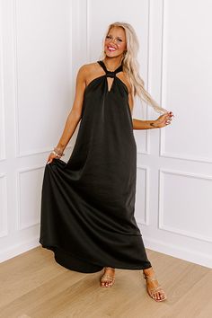 - Perfect for a date night in paradise, this gorgeous maxi is a must-have! - Satin finished material - A built-in lining ending above the knee - A v-cut neckline with a halter tied back with a keyhole detail - A flowy silhouette that ends in a maxi length hemline Solid Halter Neck Maxi Dress For Date Night, Black Halter Neck Maxi Dress With Tie Back, Solid Color Halter Neck Maxi Dress For Night Out, Black Halter Maxi Dress For Night Out, Solid Halter Neck Maxi Dress For Evening, Chic Black Halter Dress For Beach, Black Floor-length Halter Dress For Night Out, Chic Black Halter Dress For The Beach, Chic Floor-length Halter Dress For Vacation