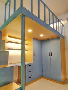 a room with stairs, cabinets and cupboards in the corner on the floor is lit by recessing lights