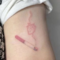 a small tattoo on the back of a woman's leg with a pencil in it