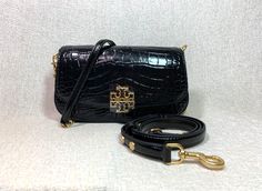 You Are Looking At A Very Beautiful Black Croc Embossed Leather Britten Convertible Bag By Tory Burch Visit my store for a wide selection of beautiful leather bags CLICK HERE ---> Visit My eBay Store MonarcoMonarco 100% Authentic Tory Burch Guaranteed !!!! Purchased from Tory Burch Outlet. Retail: $558.00 + TAX  Britten Cross Body Bag/Shoulder Bag/Clutch by Tory Burch This bag is made of black color embossed genuine leather Chain strap and adjustable leather strap are both removable, so you can use the bag as a clutch or cross body bag or shoulder bag. Dimensions: 8.5" widest x 4.75" tall center x 2.5" deep. Magnetic button and flap closure Interior: Single compartment with 1 zipper pocket and one slip pocket Fabric lining. Gold tone metalware. OUTLET ITEM DOESN'T COME WITH DUST BAG !!! WI Tory Burch Outlet, Tory Burch Britten, Convertible Bags, Leather Chain, Leather Bags, Cross Body Bag, Bag Shoulder, Beautiful Bags, Embossed Leather