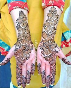 two hands with henna designs on them