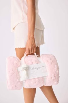 a woman carrying a pink fluffy bag