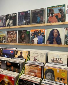 the shelves are full of various records and cds for sale in a store or music store