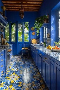 a kitchen with blue cabinets and yellow accents on the counter tops, along with an intricately painted tile floor