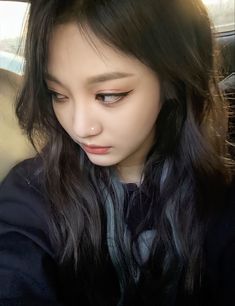 a young woman sitting in the back seat of a car