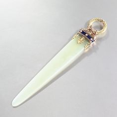 a white toothbrush with a ring on top of it