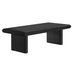 a black bench sitting on top of a white wall