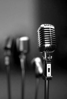 three microphones are lined up next to each other in black and white photo,