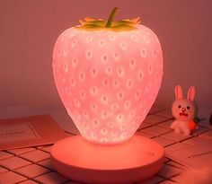 a strawberry shaped light sitting on top of a table