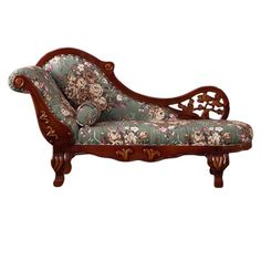 an ornate wooden chaise lounger with floral upholster