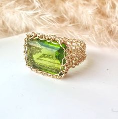 14k Gold Peridot Ring:    ♥ Gemstone Type - Peridot (Lab Created) ♥ Gemstone Size - 13x18mm ♥ Gemstone Cut - Rectangle ♥ Metal Type - 14k Gold Filled - (Other options available in the drop-down menu) ♥ Tarnish Resistant This Fine 14k Gold Peridot Ring is sure to grab compliments, dress up your casual outfit with a remarkable large stone ring, Gold Statement Ring made of 14k Gold-filled wire crochet statement band with Precious Stone - Peridot Rectangle.  This Green Stone ring will make any woman Gold Rectangular Rings With Accent Stones, Rectangular Gold Rings With Accent Stones, Gold Square Cut Emerald Ring With Gemstone, Rectangular Gold Emerald Ring, Elegant Peridot Crystal Ring As A Gift, Handmade Elegant Peridot Rings, Elegant Peridot Crystal Ring Gift, Elegant Handmade Peridot Rings, Fine Jewelry Green Rings With Rectangular Stone