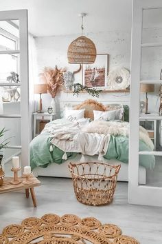 a white bedroom with wicker furniture and baskets hanging from the ceiling over the bed