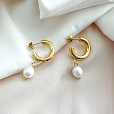 Pearl Perfection, in these contemporary yet classic white pearl dotted hoop earrings. Details:• Rhodium Plated or 18k Gold Plated Sterling Silver• White Freshwater Pearl• Size: 28mm • Post Earring Affordable Dangle Hoop Earrings With Pearl Charm, Luxury Pearl White Earrings With Pearl Charm, Gold Fashion Jewelry, Summer Earrings, Summer Earring, White Freshwater Pearl, Pearl Charms, Classic Gold, Pearl Size