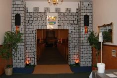 an entrance to a church with candles lit