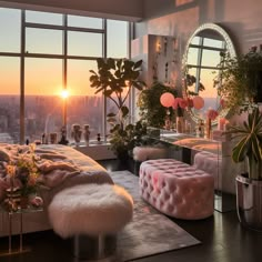 a bedroom with large windows, pink furniture and plants in the window sill at sunset