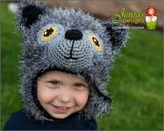 a young boy wearing a knitted animal hat