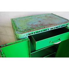 an old green metal cabinet with drawers