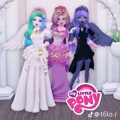 three dolls standing next to each other in front of a white wall with pink flowers