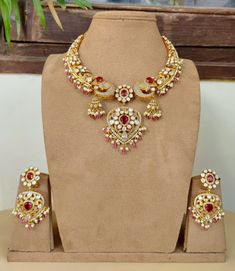 Dazzling Cz stones with crystal-work teamed with a delicate  gold frame instantly elevate any outfit. The set includes a pair of matching dangle earrings. Approximate earrings length is 2.75 inches  Free Shipping A set that has been designed with attention to detail and will compliment any outfit! Bollywood Style Diamond Kundan Necklace For Wedding, Elegant Red Kundan Necklace, Hand Set Kundan Bridal Necklace In Yellow Gold, Kundan Bridal Necklace In Yellow Gold, Yellow Gold Kundan Bridal Necklace With Hand Set, Bollywood Style Diamond Kundan Necklace With Meenakari, Elegant Jewelry With Zari Work For Reception, Festive Jeweled Diamond Bridal Necklace, Elegant Zari Work Jewelry For Reception