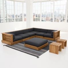 a couch and ottoman in an empty room