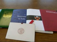 four different colored folders sitting on top of a wooden table