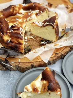 a piece of cheesecake sitting on top of a wooden cutting board