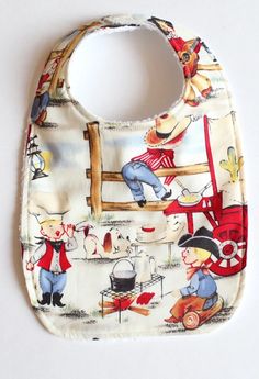 a bib with an image of children playing in the yard and on the ground