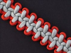 an orange and white braided bracelet on a black background