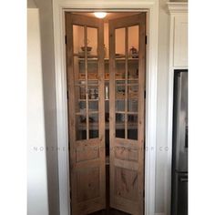 a wooden door with glass panels in a kitchen