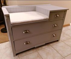 a baby crib with two drawers and a changing table in the middle of it