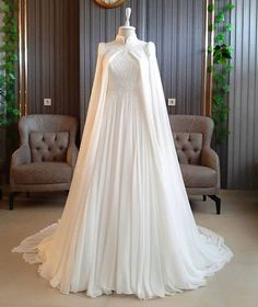 a white wedding dress on display in a room