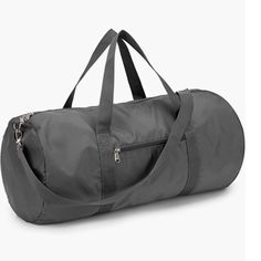 a large gray duffel bag sitting on top of a white floor