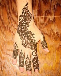 a henna tattoo is on the hand of a woman