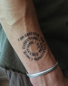 a man with a tattoo on his arm that says i am grateful for everything i have done