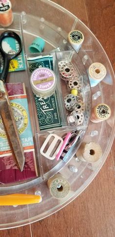 a clear tray with scissors and other crafting supplies