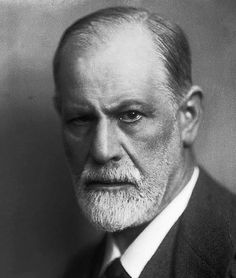 an old black and white photo of a man with a beard wearing a suit and tie