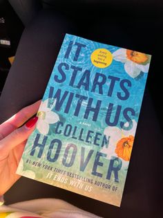 the book it starts with us by collien hoover is being held up