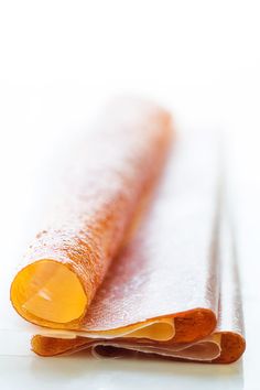 an orange piece of paper sitting on top of a white surface