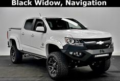 a white truck is parked in a black and white room with the words black widow navigation