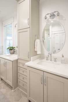 a large bathroom with two sinks and mirrors