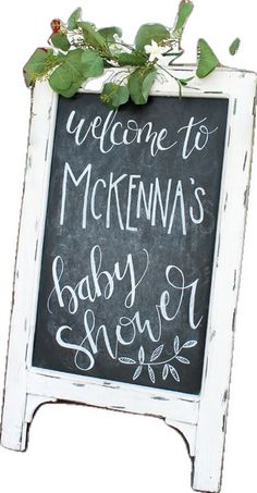 a chalkboard sign that says welcome to mckenna's baby shower