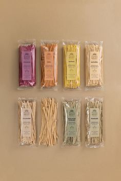 several different types of sticks in plastic bags on a table with food labels attached to them