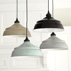 three different colored lights hanging from a ceiling