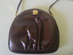 Vintage, Chocolate Brown Leather Handbag with an unique gold tone latch.  Inside is lined with brown suede/velvet fabric and has one zippered pocket.  Measures approximately 8” high x 8 ¾” wide and 2 ½” deep.Strap drop is 18".Prices are listed for Canada and USA only but if you wish to have them shipped elsewhere, please message me the shipping address and I will gladly send you a quote. Formal Leather Bag With Gold Clasp, Evening Leather Bag With Gold Clasp, Leather Evening Bag With Gold Clasp, Classic Brown Party Bag, Elegant Evening Shoulder Bag With Leather Backing, Brown Evening Bag With Zipper Closure, Geometric Scarf, Brown Leather Handbag, Vintage Chocolate