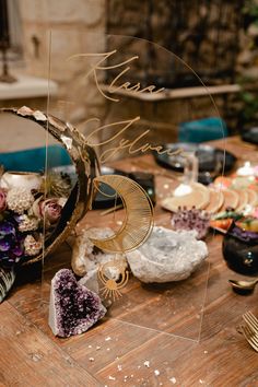 a table topped with lots of different types of flowers and other things on top of it