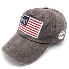 a gray hat with an american flag patch on the front and white lettering that says,